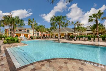 Resort-inspired pool with waterfall, cabanas & covered lanai